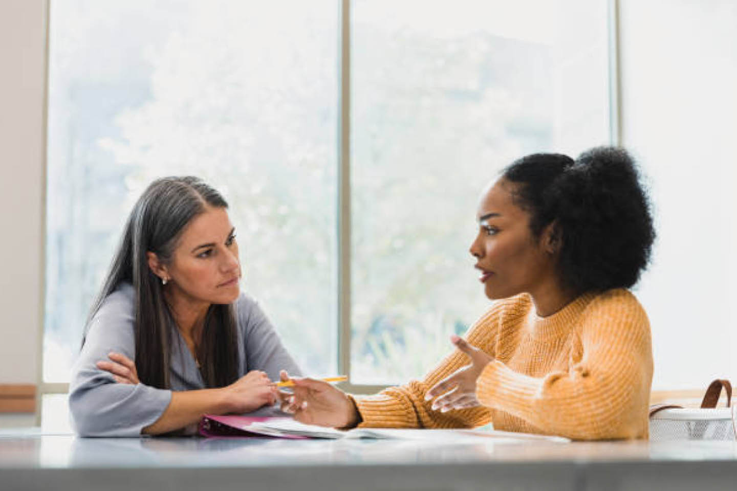 a one on one meeting between a teacher and a student.