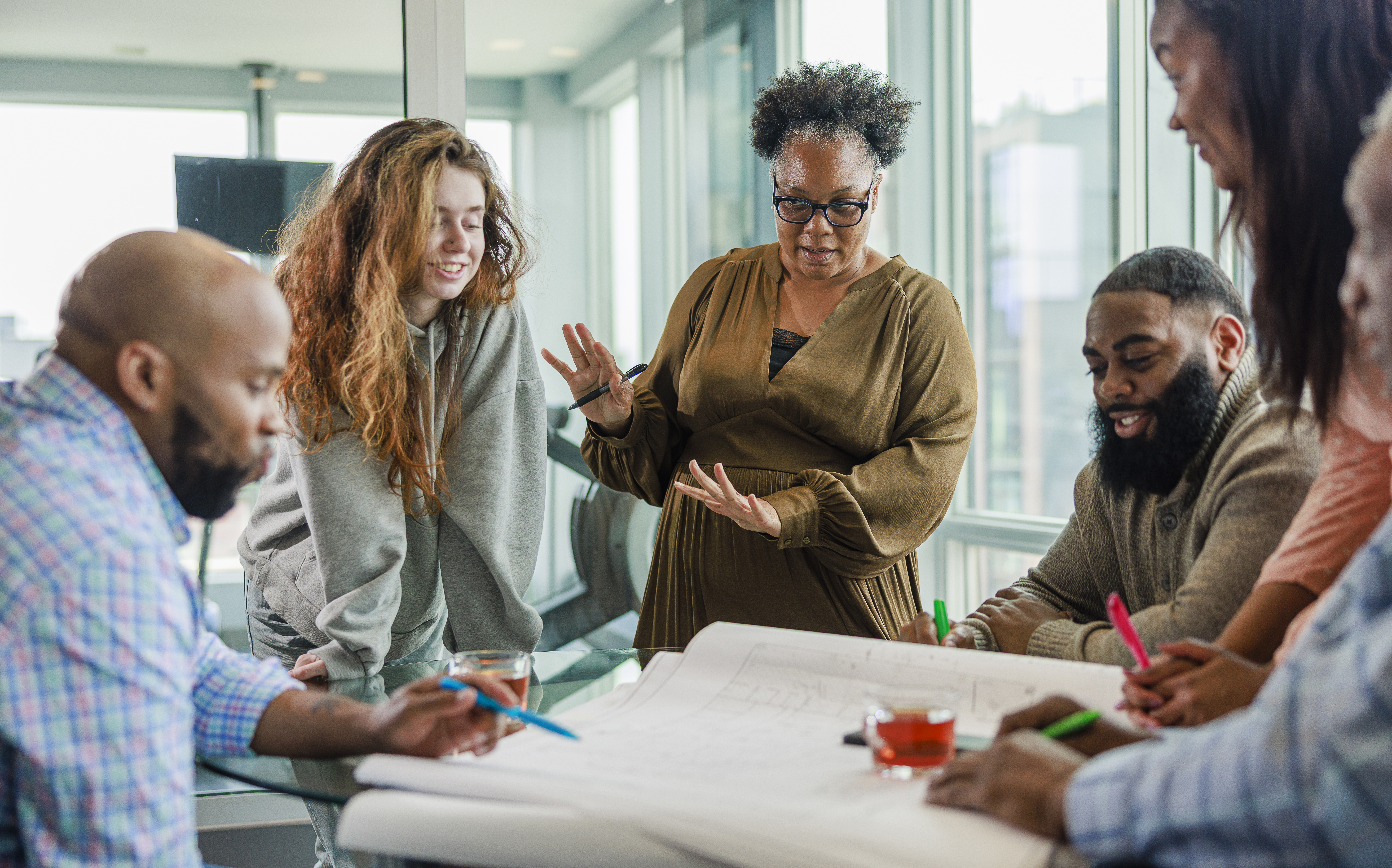 Multicultural group of teachers and district leaders strategizing how to launch their implementation of new math HQIM curriculum.