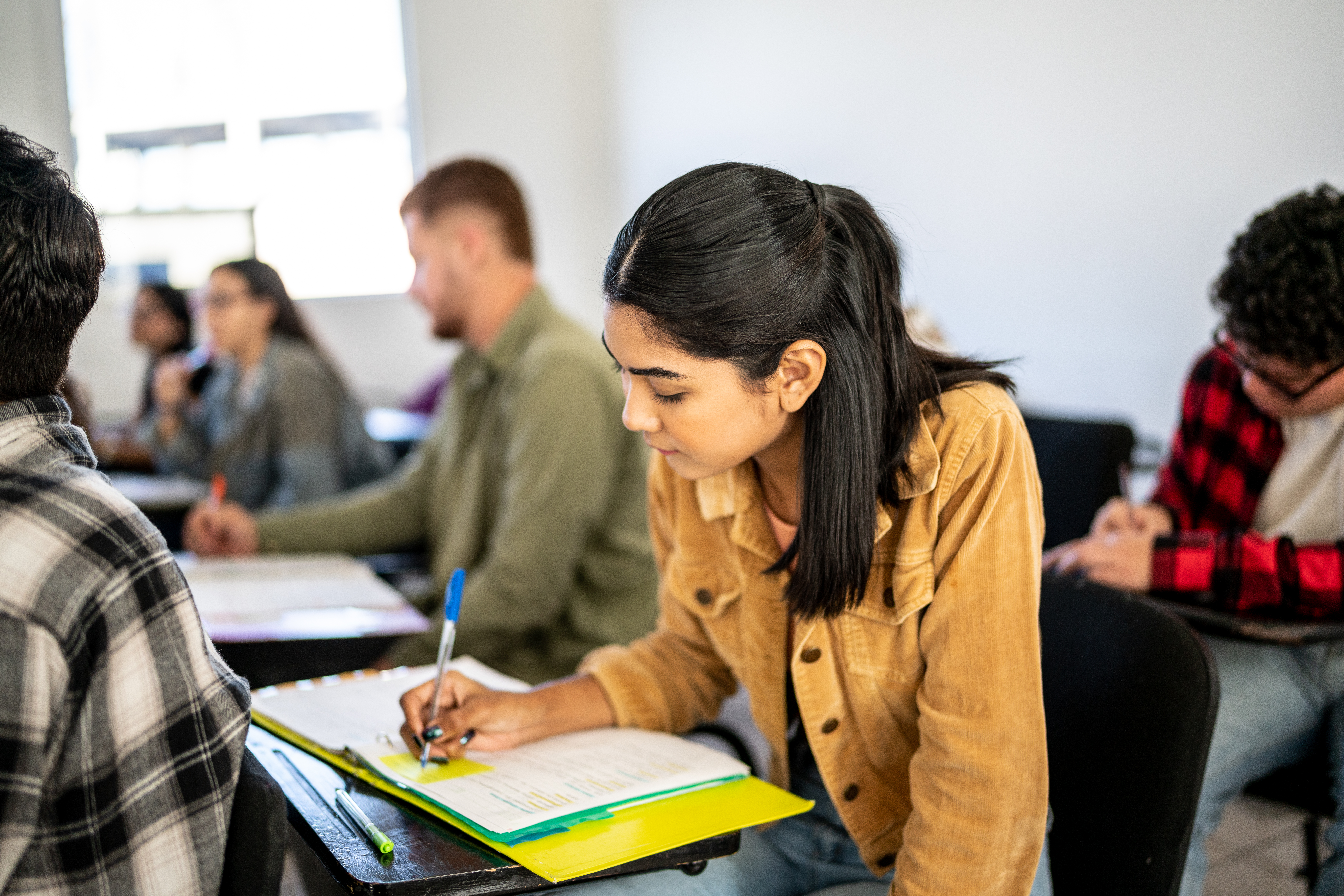 Young Hispanic woman studying in the classroom in Texas.